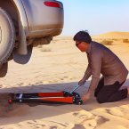 Эвакуация автомобиля с сорванным колесом в Казахстане: правильное использование подкатной тележки